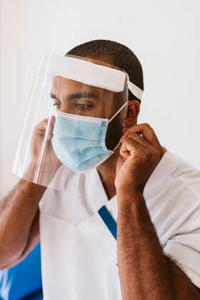 Male doctor wearing protective face mask and face shield during COVID-19 Sweden, Stockholm, model released, property released Copyright: xMaskotx , MA86741