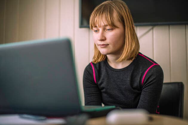Girl E-learning through laptop in living room at home Sweden, Kiruna, model released Copyright: xMaskotx , MA86993