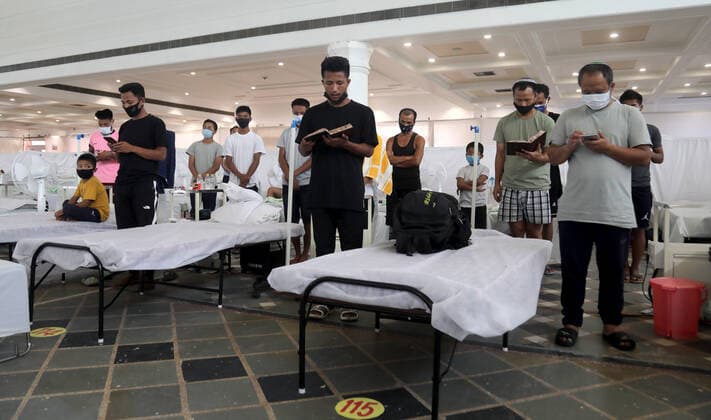 June 1, 2021, New Delhi, India: Covid-19 suspected patients, Jewish people from Manipur reading Jewish prayer books Shavei israel siddur while offering prayers at the covid-19 care center..All 38 Jewish people from Manipur (State in Northeastern India) supposed to leave for Israel but could not catch the flight after being detected Covid-19 positive..The Guru Teg Bahadur covid-19 Care Centre has 400 beds with all facility equipped with essential oxygen support and medicine for the patient at free of cost only for those with an oxygen saturation level of 85 and above can be admitted, set up by Delhi Sikh Gurudwara Management Committee (DSGMC) with the help from International Aid organizations and Delhi government. New Delhi India - ZUMAs197 20210601_zaa_s197_171 Copyright: xNaveenxSharmax