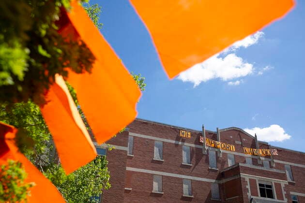 June 1, 2021, Muskowekwan First Nation, SK, Canada: Orange flags wave in front of a banner posted on the former Muscowequan Indian Residential School, one of the last residential schools to close its doors in Canada in 1997 and the last fully intact residential school still standing in Saskatchewan at Muskowekwan First Nation, Sask., on Tuesday, June 1, 2021. The vigil was in response to the remains of 215 children recently found at the Kamloops Indian Residential School. Muskowekwan First Nation Canada  - ZUMAc35_ 20210601_zaf_c35_080 Copyright: xKaylexNeisx