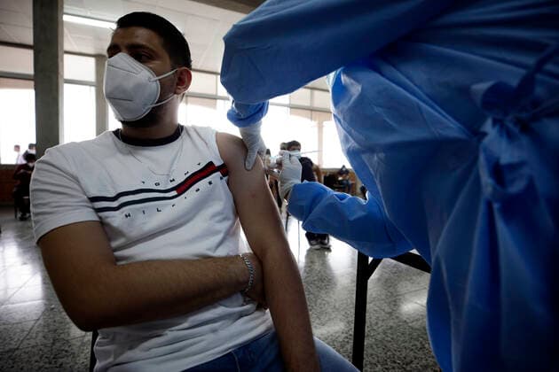 June 1, 2021 - Tegucigalpa , Honduras - A young man is immunized against covid-19. Tegucigalpa, Honduras. Hundreds of people who contribute to the (IHSS) Honduran Social Security Institute approach vaccination centers to receive the first dose of the Astrazeneca vaccine against covid-19, Honduras so far has 238,227 positive cases and 6,353 deaths. Tegucigalpa Honduras  - ZUMAf149 20210601_int_f149_007 Copyright: xMiloxEspinozax