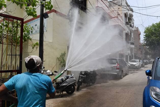 NEW DELHI, INDIA - JUNE 1: A North Delhi Municipal Corporation worker sanitizing an area as a preventive measure against the spread of the Covid-19 at Karol Bagh on June 1, 2021 in New Delhi, India. (Photo by Ajay Aggarwal Hindustan Times) Sanitation Drive To Curb The Covid-19 Pandemic