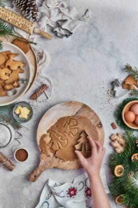 Top view of an anonymous woman preparing desserts for christmas at a table with christmas decorations Copyright: xAnaxGomezx Model Released