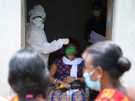 (210602) -- AGARTALA, June 2, 2021 -- A medical worker takes a swab sample from a woman for COVID-19 test in Agartala, India, June 2, 2021. (Str Xinhua) INDIA-AGARTALA-COVID-19-TEST AbhisekxSaha 
