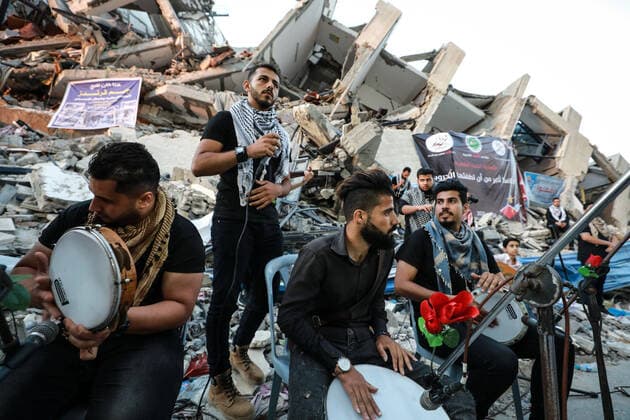 Aftermath of Palestine Israel conflict Palestinian singers perform on rubble of a building that collapsed after it was hit by airstrikes during an 11-day war between Gaza s Hamas rulers and Israel, in Gaza City on June 2, 2021. Gaza Palestinian Territories Palestine fathi-notitle210602_npfvH  Copyright: xMajdixFathix