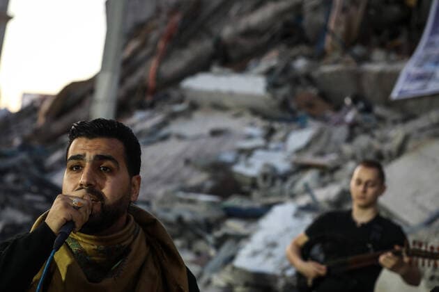 Aftermath of Palestine Israel conflict Palestinian singers perform on rubble of a building that collapsed after it was hit by airstrikes during an 11-day war between Gaza s Hamas rulers and Israel, in Gaza City on June 2, 2021. Gaza Palestinian Territories Palestine fathi-notitle210602_nplrd  Copyright: xMajdixFathix
