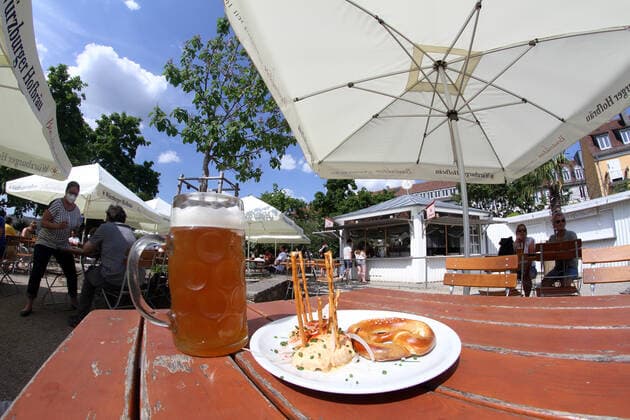 Due to low incidences in Würzburg, beer gardens were once again allowed to serve guests outdoors A mass of beer and a plate of Obatzda stand on the table of a beer garden in Sonnenschein, Bavaria, Germany