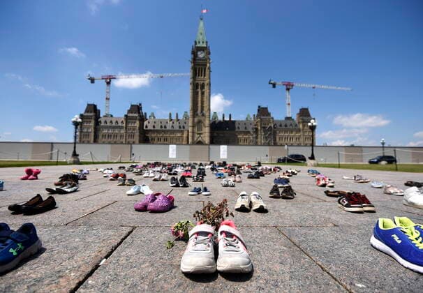 June 4, 2021, Ottawa, on, Canada: Dried flowers rest inside a pair of child s running shoes at a memorial for the 215 children whose remains were found at the grounds of the former Kamloops Indian Residential School at TkÃ¢â‚¬â ¢emlups te Secwo pemc First Nation in Kamloops, B.C., on Parliament Hill in Ottawa on Friday, June 4, 2021. Ottawa Canada  - ZUMAc35_ 20210604_zaf_c35_040 Copyright: xJustinxTangx