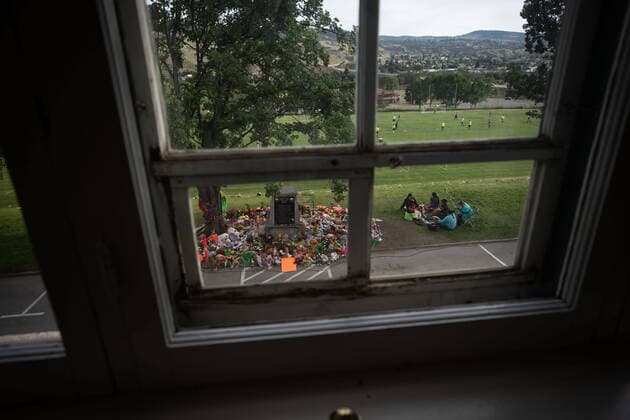 June 4, 2021, Kamloops, BC, Canada: Seen through an upper window of the former Kamloops Indian Residential School, people drum and sing beside a makeshift memorial to honour the 215 children whose remains have been discovered buried near the facility surrounds a monument, in Kamloops, B.C., on Friday, June 4, 2021. Kamloops Canada - ZUMAc35_ 20210604_zaf_c35_151 Copyright: xDarrylxDyckx