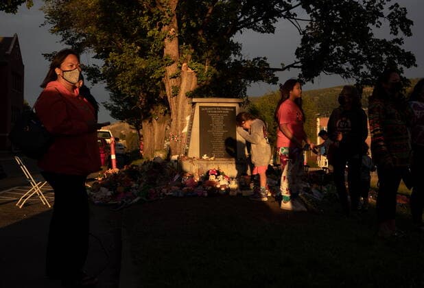 June 4, 2021, Kamloops, BC, Canada: People gather around a makeshift memorial at a monument outside the former Kamloops Indian Residential School, honouring the 215 children whose remains have been discovered buried near the facility, in Kamloops, B.C., on Friday, June 4, 2021. Kamloops Canada - ZUMAc35_ 20210604_zaf_c35_164 Copyright: xDarrylxDyckx