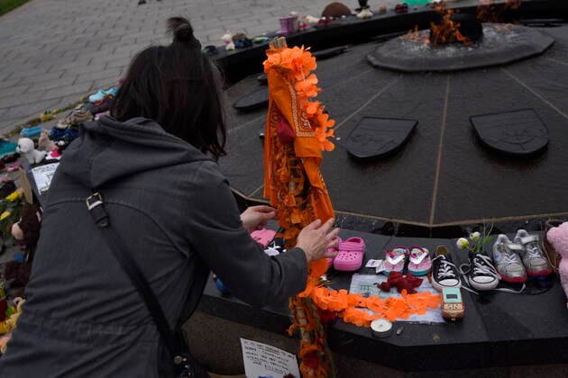 June 5, 2021, Ottawa, on, Canada: A participant places a tobacco tie on an honour staff to honour the 215 children whose remains were found at the grounds of the former Kamloops Indian Residential School at TkÃ¢â‚¬â ¢emlups te Secwo pemc First Nation in Kamloops, B.C., at the Centennial Flame on Parliament Hill in Ottawa, on Saturday, June 5, 2021. Ottawa Canada  - ZUMAc35_ 20210605_zaf_c35_014 Copyright: xJustinxTangx