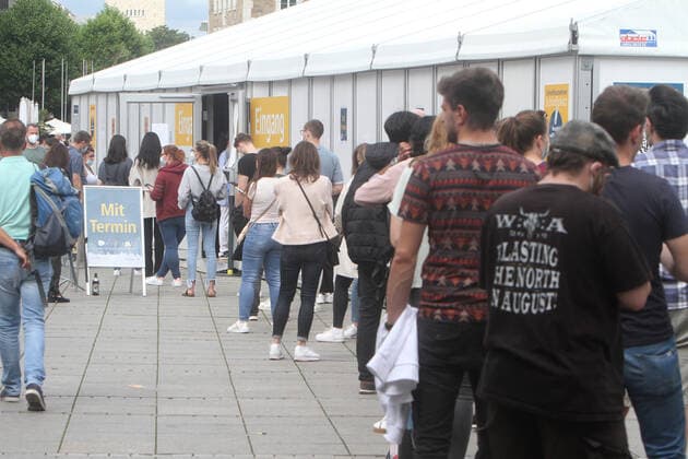 Large crowds of people seeking a free Corona rapid test outside a Corona testing center at Schlossplatz in downtown Stuttgart, Baden Württemberg, Germany