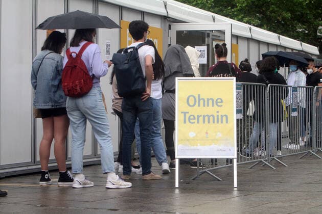 Large crowds of people seeking a free Corona rapid test outside a Corona testing center at Schlossplatz in downtown Stuttgart, Baden Württemberg, Germany