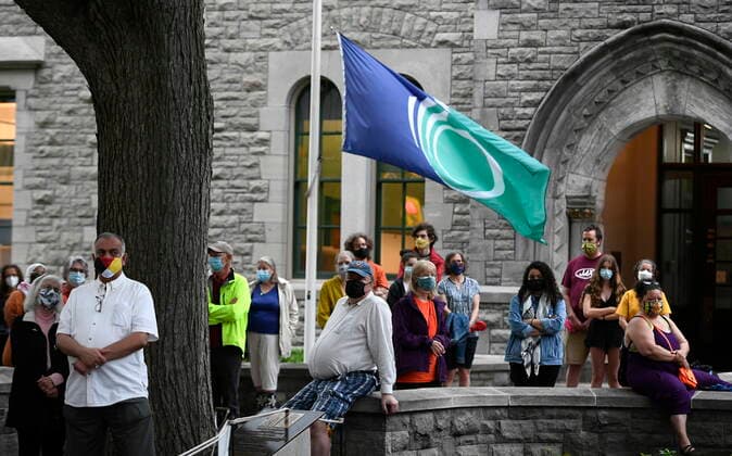 June 5, 2021, Ottawa, on, Canada: The flag of the City of Ottawa flies at half mast as people participate in a vigil held by Ottawa faith communities, to honour the 215 children whose remains were found at the grounds of the former Kamloops Indian Residential School at Tkâ€⠢emlups te Secwo pemc First Nation in Kamloops, B.C., at the Human Right s Monument in Ottawa, on Saturday, June 5, 2021. Ottawa Canada - ZUMAc35_ 20210605_zaf_c35_074 Copyright: xJustinxTangx