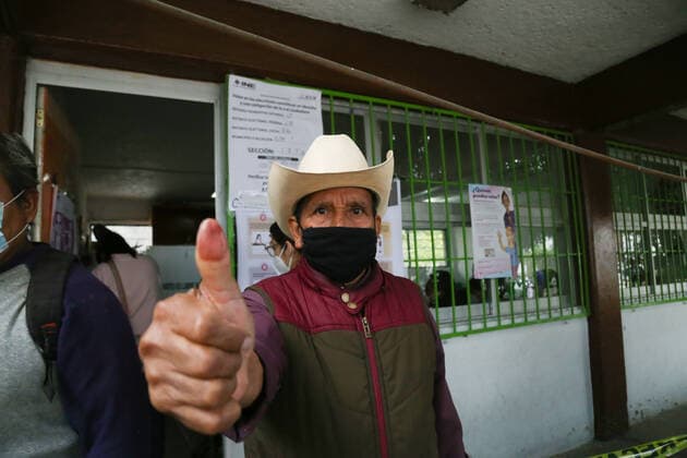 (210606) -- ECATEPEC (MEXICO), June 6, 2021 -- A man shows his inked finger after casting his ballot at a polling station during the mid-term elections in Ecatepec, Mexico, on June 6, 2021. Mexico began midterm elections on Sunday with the opening of about 161,000 polling stations throughout the country, with about 90 million people eligible to vote to fill more than 20,000 public positions. (Str Xinhua) MEXICO-ECATEPEC-MID-TERM ELECTIONS Stringer 