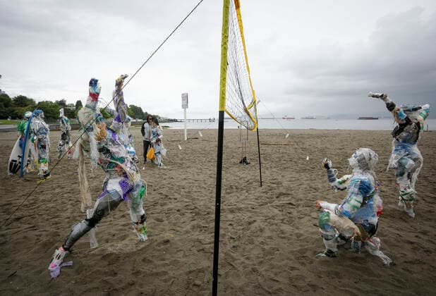 (210606) -- VANCOUVER, June 6, 2021 -- Figures made with plastics removed from shorelines are displayed at Kitsilano Beach in Vancouver, British Columbia, Canada, on June 6, 2021. Created by multidisciplinary artist Caitlin Doherty and made with plastics removed from Canadian shorelines, a set of figures named plastic beachgoers embody people s collective contribution to plastic pollution, bring the topic of shoreline pollution to the forefront. (Photo by Xinhua) CANADA-VANCOUVER-INSTALLATIONS-PLASTIC BEACHGOERS LiangxSen 