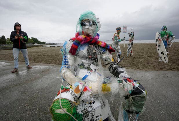 (210606) -- VANCOUVER, June 6, 2021 -- Figures made with plastics removed from shorelines are displayed at Kitsilano Beach in Vancouver, British Columbia, Canada, on June 6, 2021. Created by multidisciplinary artist Caitlin Doherty and made with plastics removed from Canadian shorelines, a set of figures named plastic beachgoers embody people s collective contribution to plastic pollution, bring the topic of shoreline pollution to the forefront. (Photo by Xinhua) CANADA-VANCOUVER-INSTALLATIONS-PLASTIC BEACHGOERS LiangxSen 