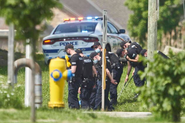 June 7, 2021, London, Ontario, Canada: A line of police officers look for evidence at the scene of a car crash in London, Ontario on Monday, June 7, 2021. Police in London, Ont., say four people have died after several pedestrians were struck by a car Sunday night. London Canada  - ZUMAc35_ 20210607_zaf_c35_025 Copyright: xGeoffxRobinsx