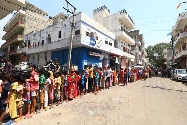 Food Distribution During Lockdown In Jaipur People stand in a queue as they wait for free food packets and face mask distributed by social workers Dr. Sarvesh Joshi and Deepak Dandoriya during the Covid-19 lockdown ,at Purani Basti in Jaipur, Rajasthan, India, on June 07, 2021. Jaipur Rajasthan India bhatnagar-notitle210607_np6nk  Copyright: xVishalxBhatnagarx