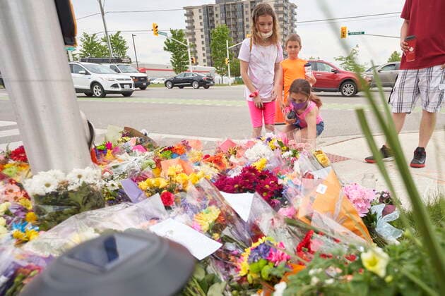 June 8, 2021, London, on, Canada: Children place flowers at the scene of a hate-motivated vehicle attack in London, Ont. on Tuesday, June 8, 2021, which left four members of a family dead and sent one to hospital. London Canada  - ZUMAc35_ 20210608_zaf_c35_021 Copyright: xGeoffxRobinsx