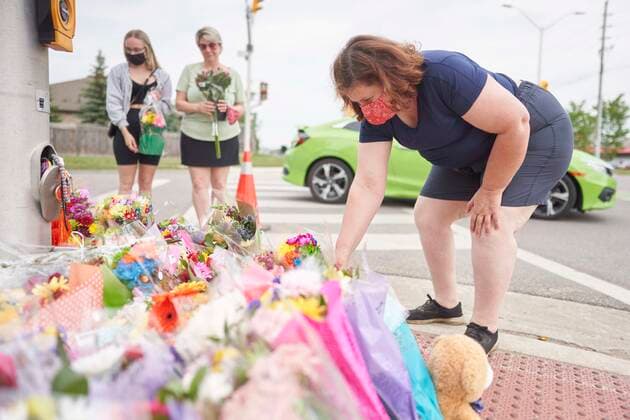 June 8, 2021, London, Ontario, Canada: A woman places flowers at the scene of a hate-motivated vehicle attack in London, Ont. on Tuesday, June 8, 2021, which left four members of a family dead and sent one to hospital on Sunday evening. London Canada  - ZUMAc35_ 20210608_zaf_c35_023 Copyright: xGeoffxRobinsx