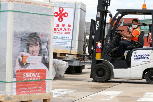 (210608) -- PHNOM PENH, June 8, 2021 -- A worker transports a package of Chinese COVID-19 vaccines at the Phnom Penh International Airport in Phnom Penh, Cambodia, June 8, 2021. Cambodia s COVID-19 vaccination drive has received another boost after the country got a new batch of Chinese vaccines on Tuesday. Cambodian health ministry s secretary of state Yok Sambath said the new arrival included Sinopharm vaccine donated by the Chinese government and those purchased from Chinese biopharmaceutical firm Sinovac Biotech. (Photo by Sovannara Xinhua) CAMBODIA-PHNOM PENH-CHINESE COVID-19 VACCINES-ARRIVAL MaoxPengfei 