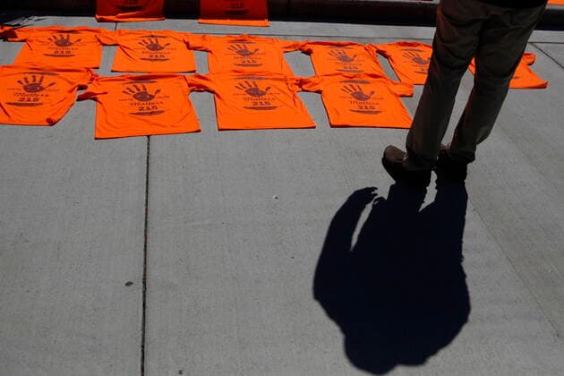 June 8, 2021, Victoria, BC, Canada: A man looks over the orange shirts, shoes, flowers and messages are displayed on the steps outside the legislature in Victoria, B.C., on Tuesday, June 8, 2021 following a ceremony hosted by the Songhees and Esquimalt First Nations in honour of the 215 residential school children whose remains have been discovered buried near the facility in Kamloops, B.C. Victoria Canada - ZUMAc35_ 20210608_zaf_c35_105 Copyright: xChadxHipolitox