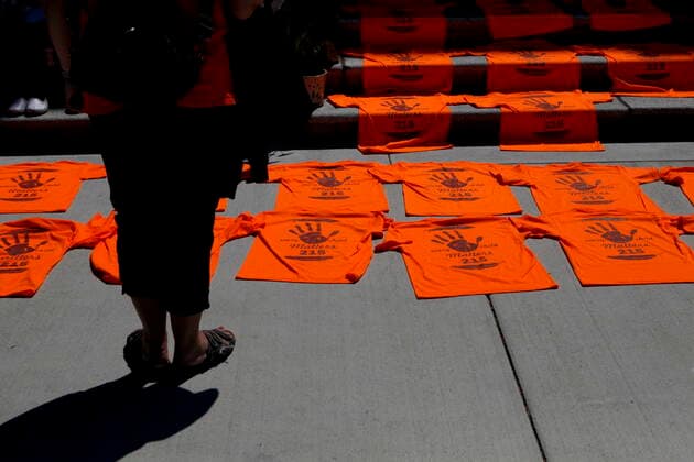 June 8, 2021, Victoria, BC, Canada: A woman looks over the orange shirts, shoes, flowers and messages are displayed on the steps outside the legislature in Victoria, B.C., on Tuesday, June 8, 2021 following a ceremony hosted by the Songhees and Esquimalt First Nations in honour of the 215 residential school children whose remains have been discovered buried near the facility in Kamloops, B.C. Victoria Canada - ZUMAc35_ 20210608_zaf_c35_107 Copyright: xChadxHipolitox