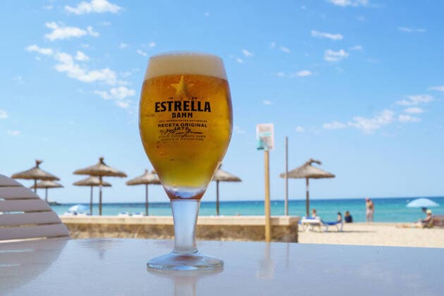 Playa Ciudad Jardin in Mallorca in the second year of Corona Pandemic Early Summer 2021 Estrella Damm is a Spanish Pilsner beer and the main brand of the Barcelona-based brewery S A Damm Playa Ciudad Jardin in Mallorca in the second year of C