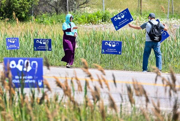 June 12, 2021, London, on, Canada: People place signs before the funeral service for the victims of the deadly vehicle attack on five members of the Canadian Muslim community in London, Ont., on Saturday, June 12, 2021. Four members of the family died and one is in critical but stable condition. A 20 year-old male is in custody and has been charged in what police say is a motivated hate crime. London Canada  - ZUMAc35_ 20210612_zaf_c35_021 Copyright: xNathanxDenettex