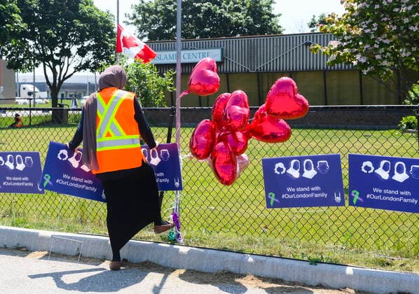 June 12, 2021, London, on, Canada: Elaaf Siddiqui, 23, places signs before the funeral service for the victims of the deadly vehicle attack on five members of the Canadian Muslim community in London, Ont., on Saturday, June 12, 2021. Four members of the family died and one is in critical but stable condition. A 20 year-old male is in custody and has been charged in what police say is a motivated hate crime. London Canada - ZUMAc35_ 20210612_zaf_c35_023 Copyright: xNathanxDenettex
