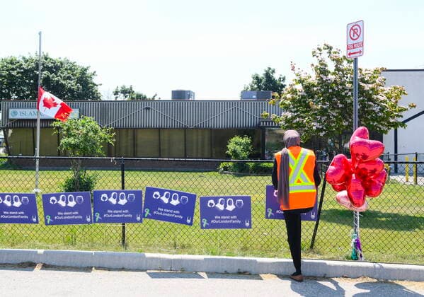 June 12, 2021, London, on, Canada: Elaaf Siddiqui, 23, places signs before the funeral service for the victims of the deadly vehicle attack on five members of the Canadian Muslim community in London, Ont., on Saturday, June 12, 2021. Four members of the family died and one is in critical but stable condition. A 20 year-old male is in custody and has been charged in what police say is a motivated hate crime. London Canada - ZUMAc35_ 20210612_zaf_c35_024 Copyright: xNathanxDenettex