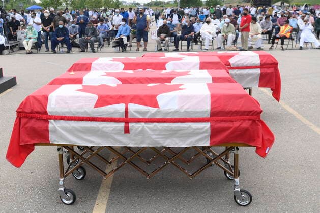 June 12, 2021, London, on, Canada: Caskets draped in Canadian flags are lined up at a funeral for the four Muslim family members killed in a deadly vehicle attack, at the Islamic Centre of Southwest Ontario in London, Ont., on Saturday, June 12, 2021. Talat Afzaal, 74, her son Salman Afzaal, 46, his wife Madiha Salman, 44, and their 15-year-old daughter Yumna Salman all died last Sunday night while out for a walk after a man in a truck drove them down in what police have called a premeditated attack because they were Muslim. London Canada - ZUMAc35_ 20210612_zaf_c35_048 Copyright: xNathanxDenettex