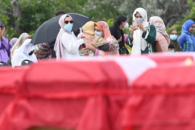 June 12, 2021, London, on, Canada: Family members comfort each behind caskets draped in Canadian flags at a funeral for the four Muslim family members killed in a deadly vehicle attack, at the Islamic Centre of Southwest Ontario in London, Ont., on Saturday, June 12, 2021. Talat Afzaal, 74, her son Salman Afzaal, 46, his wife Madiha Salman, 44, and their 15-year-old daughter Yumna Salman all died last Sunday night while out for a walk after a man in a truck drove them down in what police have called a premeditated attack because they were Muslim. London Canada - ZUMAc35_ 20210612_zaf_c35_058 Copyright: xNathanxDenettex