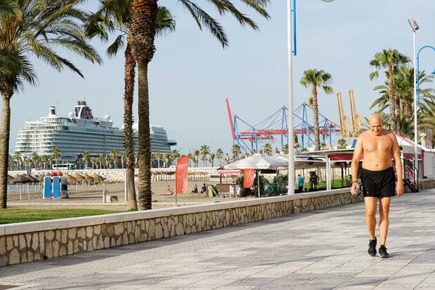 June 15, 2021, Malaga, Spain: A topless man walks at Malagueta Beach in Malaga in front of Mein Schiff 2 cruise..Mein Schiff 2 is the first international cruise that has docked at Iberian Peninsula since Covid19 pandemic started. Spain lifted the ban for international cruise ships to dock in Spanish ports on May 30th. Malaga Spain - ZUMAs197 20210615_zaa_s197_046 Copyright: xFrancisxGonzalezx
