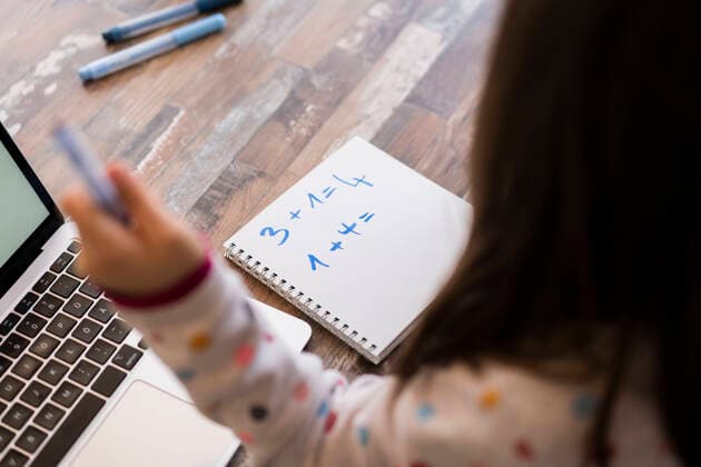 Girl with book and laptop studying Mathematics at home model released Symbolfoto property released JOSEF04139