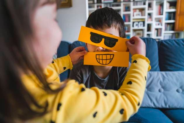Siblings playing with emoticons at home model released Symbolfoto property released MGIF01073