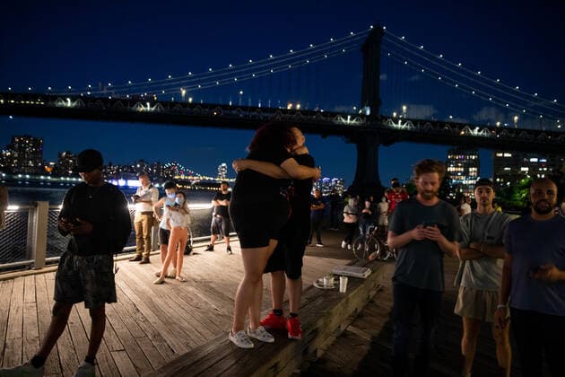 (210616) -- NEW YORK, June 16, 2021 -- People hug during a fireworks show in a bid to celebrate New York s achievement of the vaccination milestone from the Brooklyn borough of New York, the United States, on June 15, 2021. New York State Governor Andrew Cuomo Tuesday announced the immediate lifting of major COVID-19 restrictions across the state as 70 percent of adults in the state have received at least one dose of COVID-19 vaccine. ) U.S.-NEW YORK-VACCINATION MILESTONE MichaelxNagle 