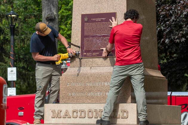 Kanada, Entfernung der Statue von ex-Premierminister John Macdonald in Kingston, Ontario June 18, 2021, Kingston, Ontario, Canada: Workers remove a plaque on the monument that held the statue of Sir John A Macdonald in Kingston, Ontario on Friday June 18, 2021. The statue will be removed from a park in his hometown of Kingston while his name will be taken off a local school. Kingston s city council voted this week to take the statue from City Park, place it temporarily in storage, and eventually put it up in Kingston Cataraqui Cemetery where Canada s first prime minister is buried. Kingston Canada - ZUMAc35_ 20210618_zaf_c35_034 Copyright: xLarsxHagbergx