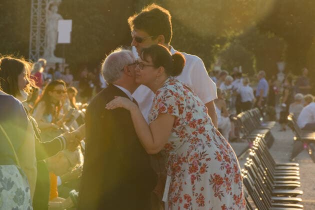 (210619) -- VIENNA, June 19, 2021 -- People greet each other before the Summer Night Concert starts at the Schoenbrunn Palace in Vienna, Austria, June 18, 2021. The Summer Night Concert 2021 was staged on Friday by the Vienna Philharmonic Orchestra at the Schoenbrunn Palace, a world heritage site in Vienna. About 3,000 spectators are allowed to watch the concert face to face after the COVID-19 restrictions were partially lifted. ) AUSTRIA-VIENNA-SUMMER NIGHT CONCERT GuoxChen 