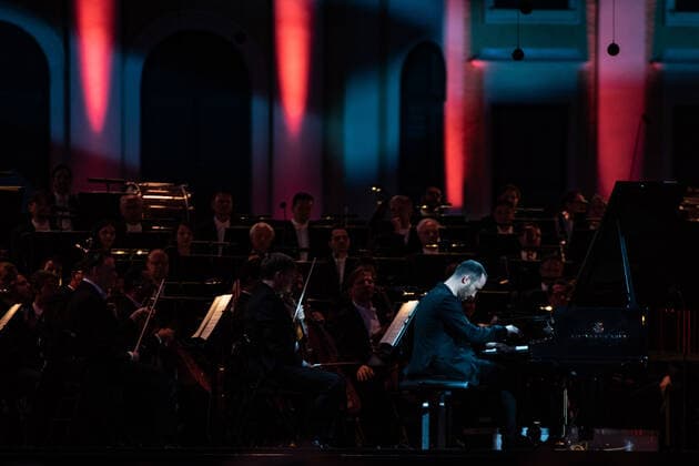 (210619) -- VIENNA, June 19, 2021 -- Pianist Igor Levit performs on the stage during the Summer Night Concert at the Schoenbrunn Palace in Vienna, Austria, June 18, 2021. The Summer Night Concert 2021 was staged on Friday by the Vienna Philharmonic Orchestra at the Schoenbrunn Palace, a world heritage site in Vienna. About 3,000 spectators are allowed to watch the concert face to face after the COVID-19 restrictions were partially lifted. ) AUSTRIA-VIENNA-SUMMER NIGHT CONCERT GuoxChen 