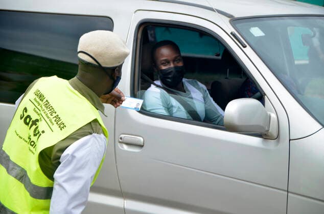(210620) -- KAMPALA, June 20, 2021 -- A traffic police officer checks documents at a check point in Kampala, Uganda, June 19, 2021. Ugandan President Yoweri Museveni on Friday announced a string of measures aimed at containing the rapid spread of the novel coronavirus as the country is experiencing a second wave. (Photo by Xinhua) UGANDA-KAMPALA-ANTI-COVID-19-MEASURES NicholasxKajoba 