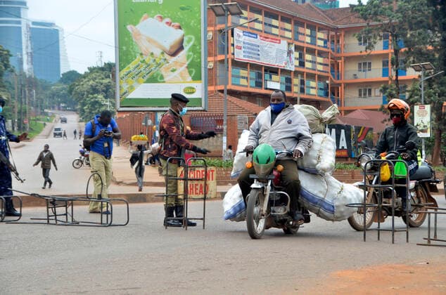 (210620) -- KAMPALA, June 20, 2021 -- A security guard stops a motorcyclist at a checkpoint in Kampala, Uganda, June 19, 2021. Ugandan President Yoweri Museveni on Friday announced a string of measures aimed at containing the rapid spread of the novel coronavirus as the country is experiencing a second wave. (Photo by Xinhua) UGANDA-KAMPALA-ANTI-COVID-19-MEASURES NicholasxKajoba 