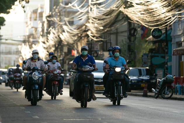 (210620) -- VIENTIANE, June 20, 2021 -- Motorcyclists wearing face masks ride on a street in Vientiane, Laos, June 19, 2021. Laos has extended its lockdown COVID-19 prevention measures across the country for a further 15 days as the community spread of COVID-19 in the capital continues. (Photo by Xinhua) LAOS-VIENTIANE-COVID-19-LOCKDOWN KaikeoxSaiyasane 