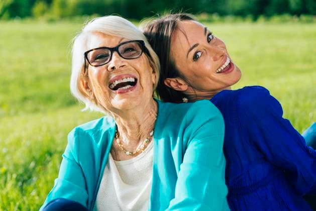 Happy senior woman with mid-adult woman sitting in park model released Symbolfoto OIPF00883