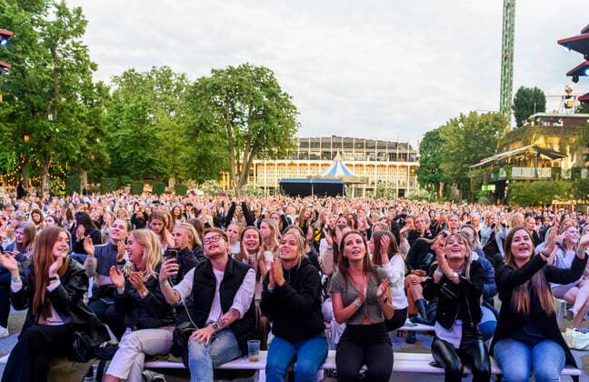 An enthusiastic audience for Danish Christopher who plays up to Havefest paa Plaenen in Tivoli on Friday 25 June 2021 with seated audience divided into two sections Havefest replaces Fredagsrock, which has been canceled due to the Covid 19 Corona crisis, Copenhagen  Copyright: TorbenxChristensen TorbenxChristensenx COP333 spdk20210626-010340-L