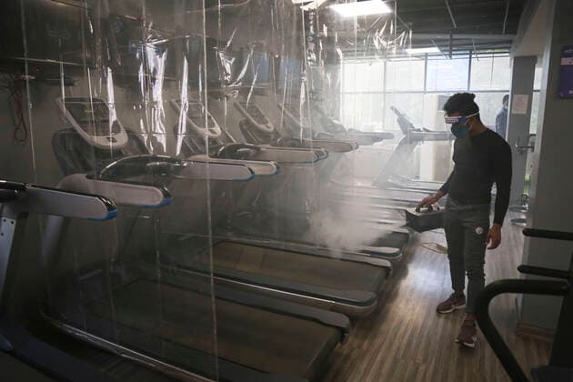 NEW DELHI, INDIA JUNE 27: A worker chemically disinfects the premises at Anytime Fitness Gym ahead of its reopening tomorrow following the Delhi government?s nod, at Malviya Nagar, on June 27, 2021 in New Delhi, India. Gyms and yoga centres have been allowed to reopen in Delhi from Monday at 50% capacity, an official government order said. Banquet halls, marriage halls, and hotels have also been permitted to host weddings, but the number of guests has been capped at 50, the order said. (Photo by Sanchit Khanna Hindustan Times ) Delhi Unlock 5: Gyms, Banquet Halls, Hotels To Open From Monday