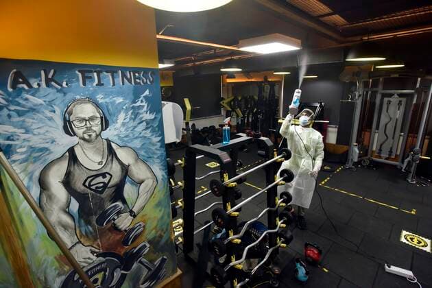 NEW DELHI, INDIA JUNE 27: Workers in PPE coveralls sanitizing the premises of a gym, at A.K.Fitness 24x7 in Jangpura, on June 27, 2021 in New Delhi, India. Gyms and yoga centres have been allowed to reopen in Delhi from Monday at 50% capacity, an official government order said. Banquet halls, marriage halls, and hotels have also been permitted to host weddings, but the number of guests has been capped at 50, the order said. (Photo by Sanjeev Verma Hindustan Times ) Delhi Unlock 5: Gyms, Banquet Halls, Hotels To Open From Monday