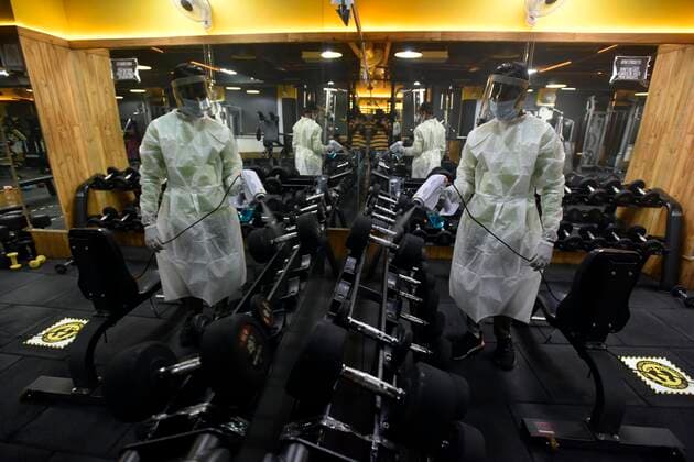 NEW DELHI, INDIA JUNE 27: Workers in PPE coveralls sanitizing the premises of a gym, at A.K.Fitness 24x7 in Jangpura, on June 27, 2021 in New Delhi, India. Gyms and yoga centres have been allowed to reopen in Delhi from Monday at 50% capacity, an official government order said. Banquet halls, marriage halls, and hotels have also been permitted to host weddings, but the number of guests has been capped at 50, the order said. (Photo by Sanjeev Verma Hindustan Times ) Delhi Unlock 5: Gyms, Banquet Halls, Hotels To Open From Monday