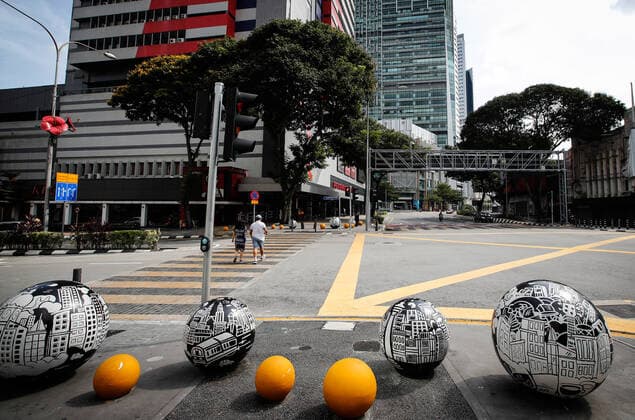 June 27, 2021, Kuala Lumpur, Malaysia: Pedestrians crossing the road along an empty street in downtown Kuala Lumpur..Malaysia government announced the one month full lockdown which is due on Monday will be extended due to the daily high number of coronavirus infections cases reported. Kuala Lumpur Malaysia - ZUMAs197 20210627_zaa_s197_066 Copyright: xWongxFokxLoyx